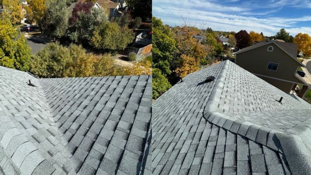 Aerial view of a residential roof with gray shingles and autumn trees in the background.